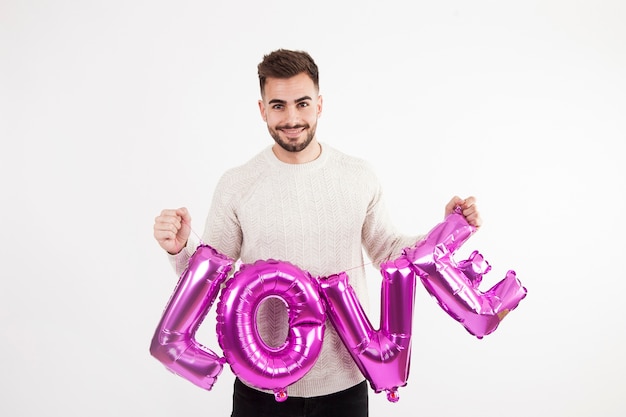 Free photo smiling man with magenta love writing