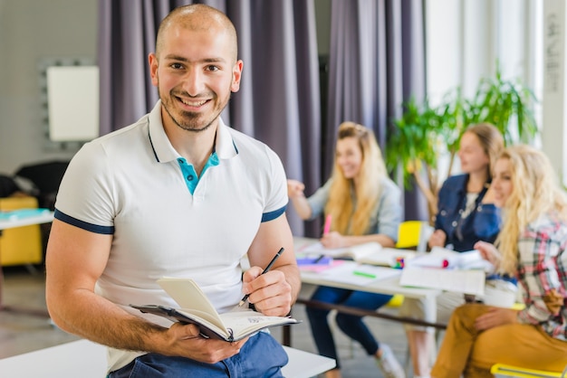 Smiling man with notebook