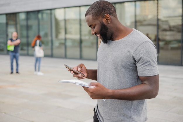 Free photo smiling man with phone and papers