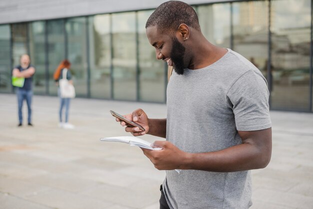 Smiling man with phone and papers