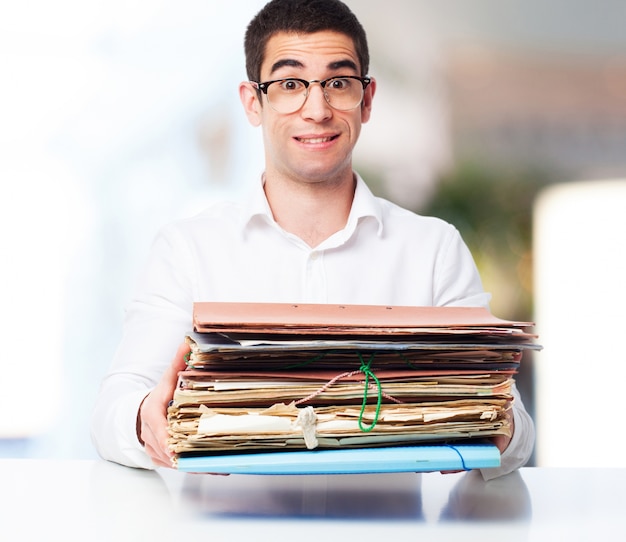 Smiling man with a pile of papers in hands