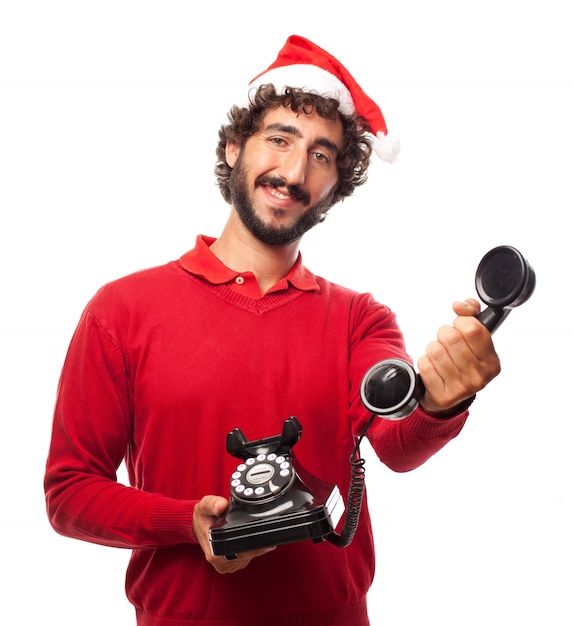 Smiling man with santa cap and a vintage phone