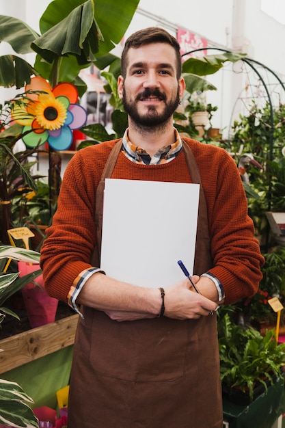 Smiling man with sheet of paper