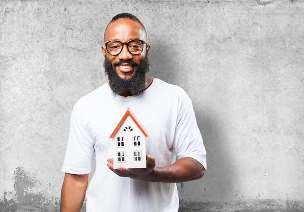 Free photo smiling man with a small house