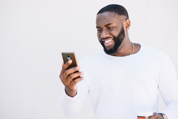 Uomo sorridente con lo smartphone