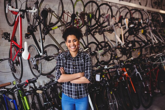 Smiling mechanic standing with arms crossed