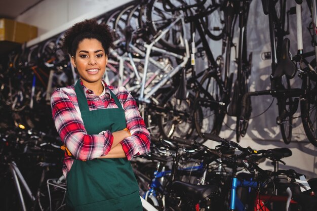 Smiling mechanic standing with arms crossed