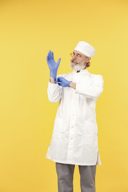 Smiling medical doctor in glasses. Isolated. Man in a blue gloves.