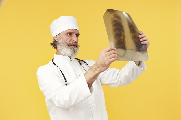 Smiling medical doctor with x-ray results. Isolated.