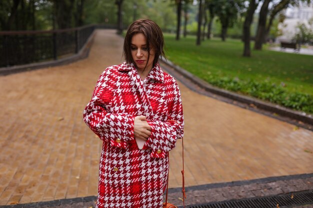 A smiling middle age woman wearing autumn clothes.