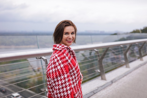 A smiling middle age woman wearing autumn clothes.