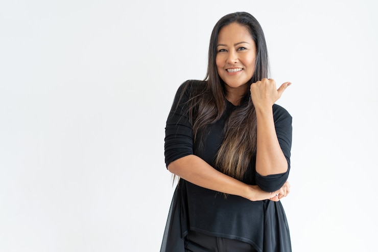 Free Photo smiling middle-aged woman pointing aside