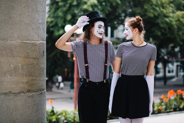 Smiling mime couple looking at each other