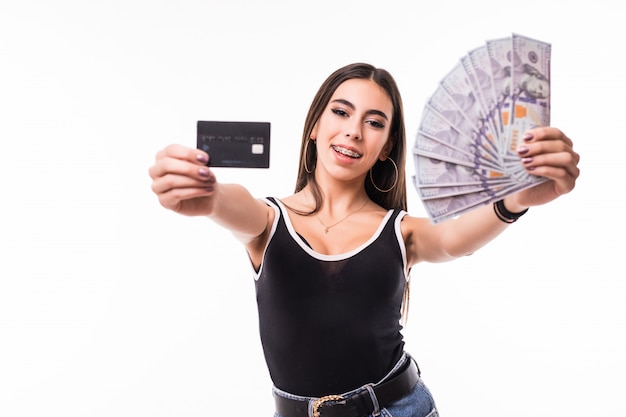 Smiling model in black shirt hold fan of dollar bills and a credit card