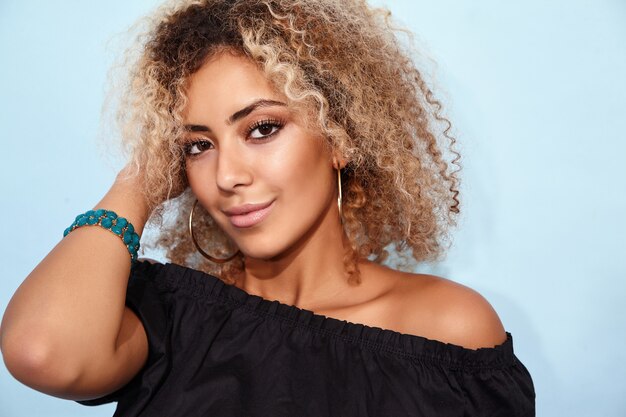 Smiling model woman in trendy summer black clothes posing