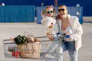 Free photo smiling mother and child after grocery shopping