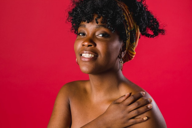 Free photo smiling naked black curly young female on colored background