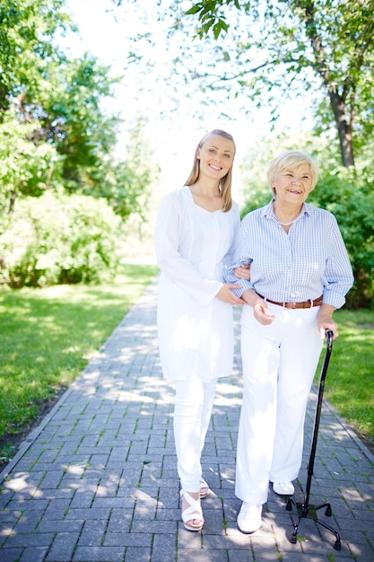 Smiling nurse assisting mature woman