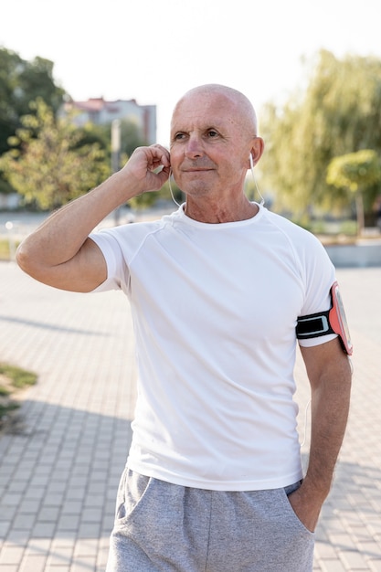 Smiling old man listening to music