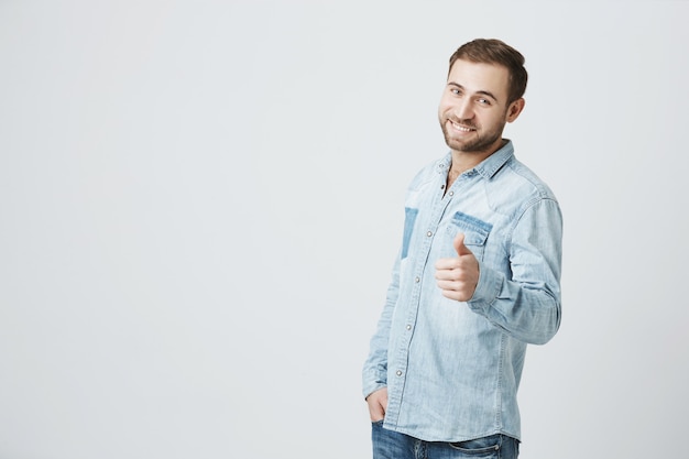 Smiling optimistic man show thumb-up