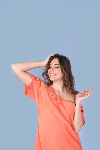 Free photo smiling passionate woman in blouse holding head