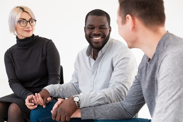 Smiling  patients holding hands and looking at each other