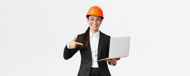 Smiling pleased asian female chief engineer showing chart with enterprise profit making presentation