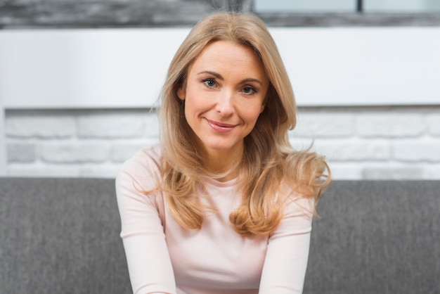 Smiling portrait of a blonde young woman looking at camera