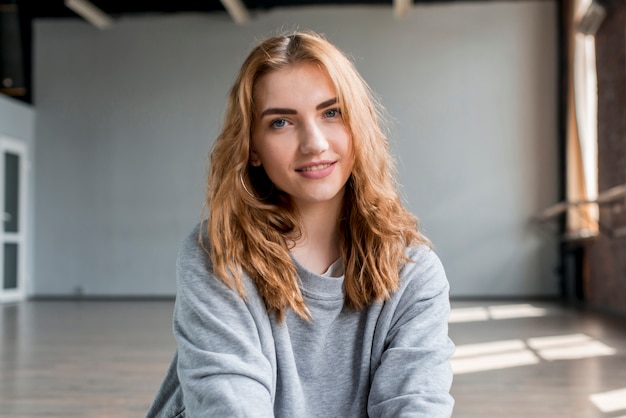 Free photo smiling portrait of a blonde young woman looking at camera