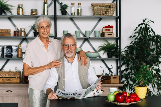 Smiling portrait of an elderly man sitting in the kitchen