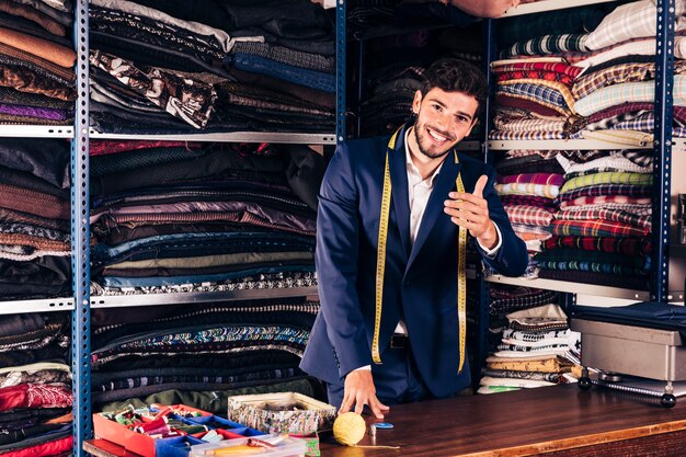 Smiling portrait of a male inviting customer in his shop