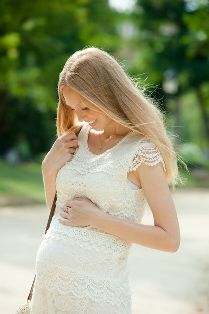 Smiling pregnant woman in park