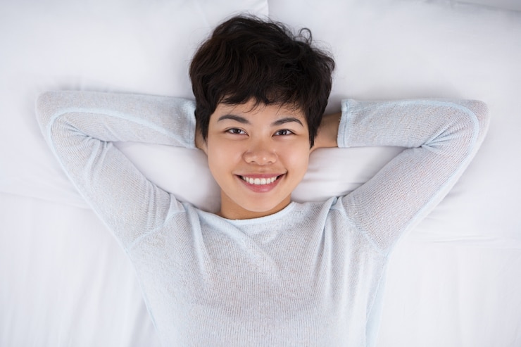 Free Photo smiling pretty asian woman resting in bed