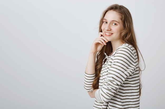 Free photo smiling pretty girl looking happy over white wall