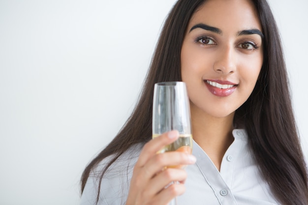 Улыбка Довольно индийский женщины, воспитывающей бокал вина