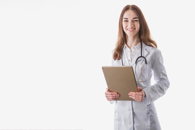 Smiling pretty woman doctor with tablet