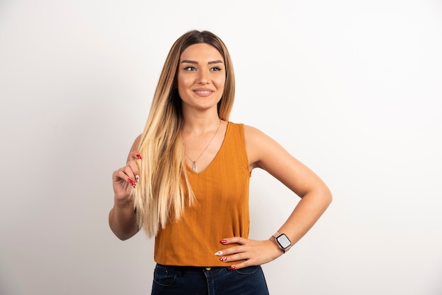 Smiling pretty young adult woman looking at camera and posing.