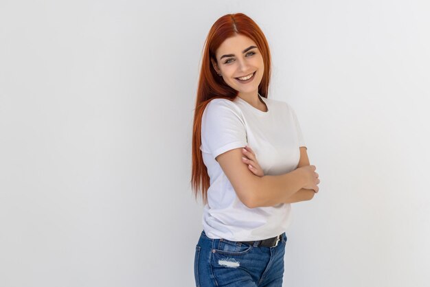 Smiling redhead woman blue eyes standing profile self-assured pose hands crossed chest turning face left amused interested, professional freelancer ready get work