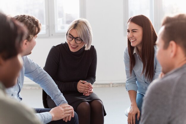 Smiling rehab patients looking at each other