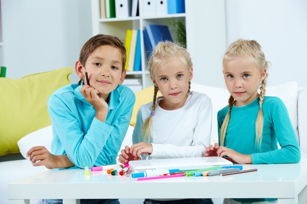 Smiling schoolboy with his sisters