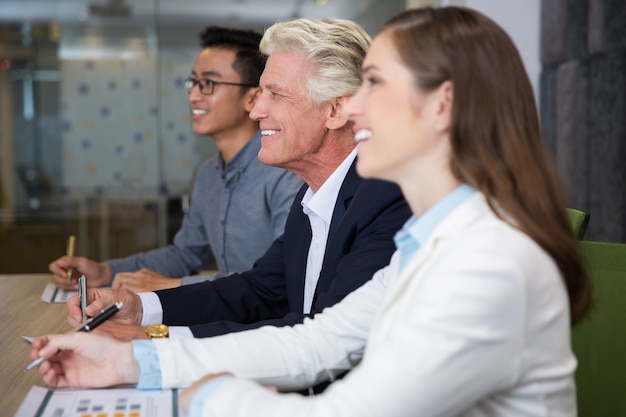 Smiling senior businessman sitting at conference