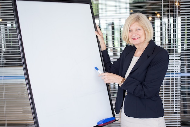 Smiling senior female leader explaining task