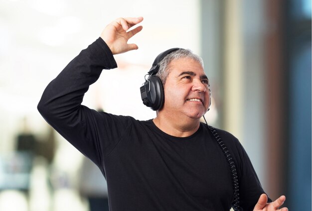 Smiling senior man listening to music