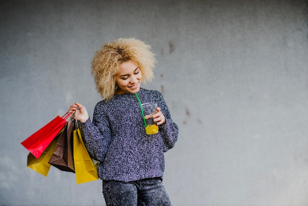 Smiling shopper with beverage