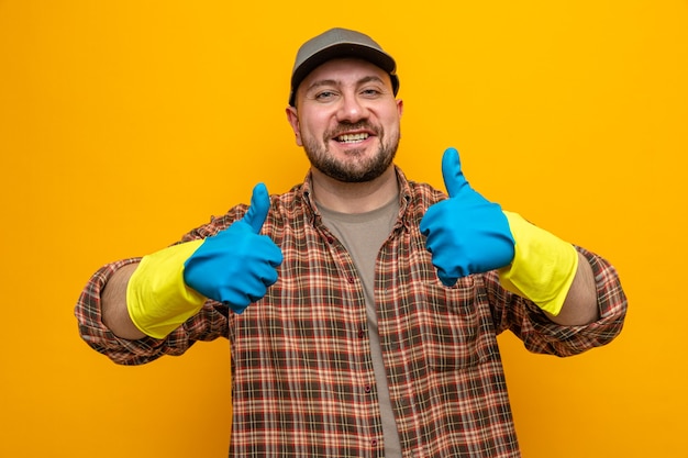 Smiling slavic cleaner man with rubber gloves thumbing up