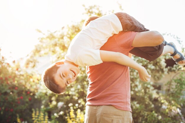 Smiling son and father having fun in park