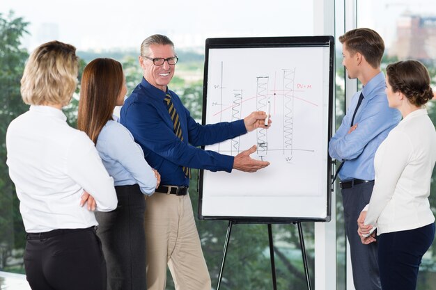 Smiling Speaker Explaining Bar Chart to Audience