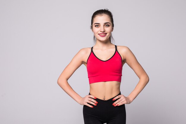 Smiling sports woman standing with arms folded
