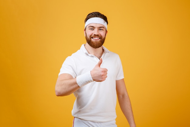 Smiling sportsman showing thumb up