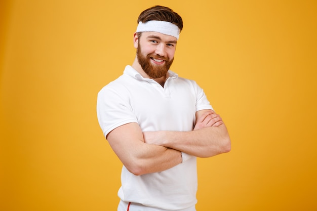 Smiling sportsman with crossed arms